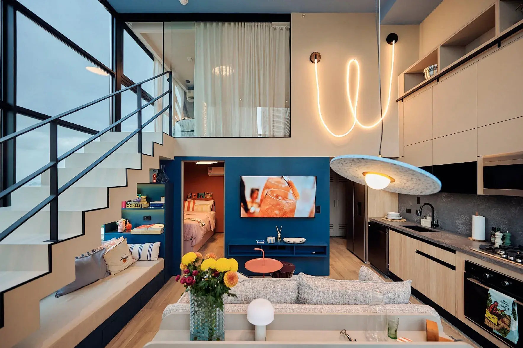 Double-height loft with a staircase to the mezzanine bedroom at Dovle Selva.