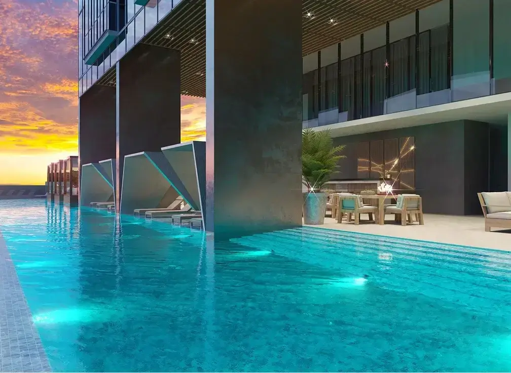 Architectural render of the Generation Tower pool at sunset, with angled concrete shades over loungers between large columns and an outdoor dining terrace.