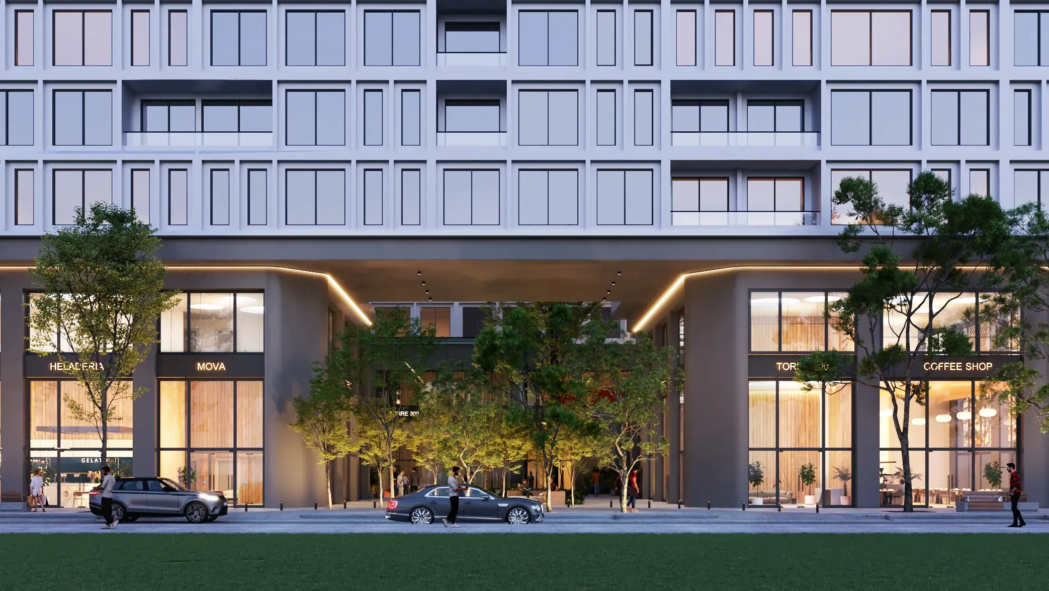 Architectural render of the MOVA Residences street frontage at dusk, with lit ground-floor shops and cafés on either side of a tree-lined covered passage and cars on the street.