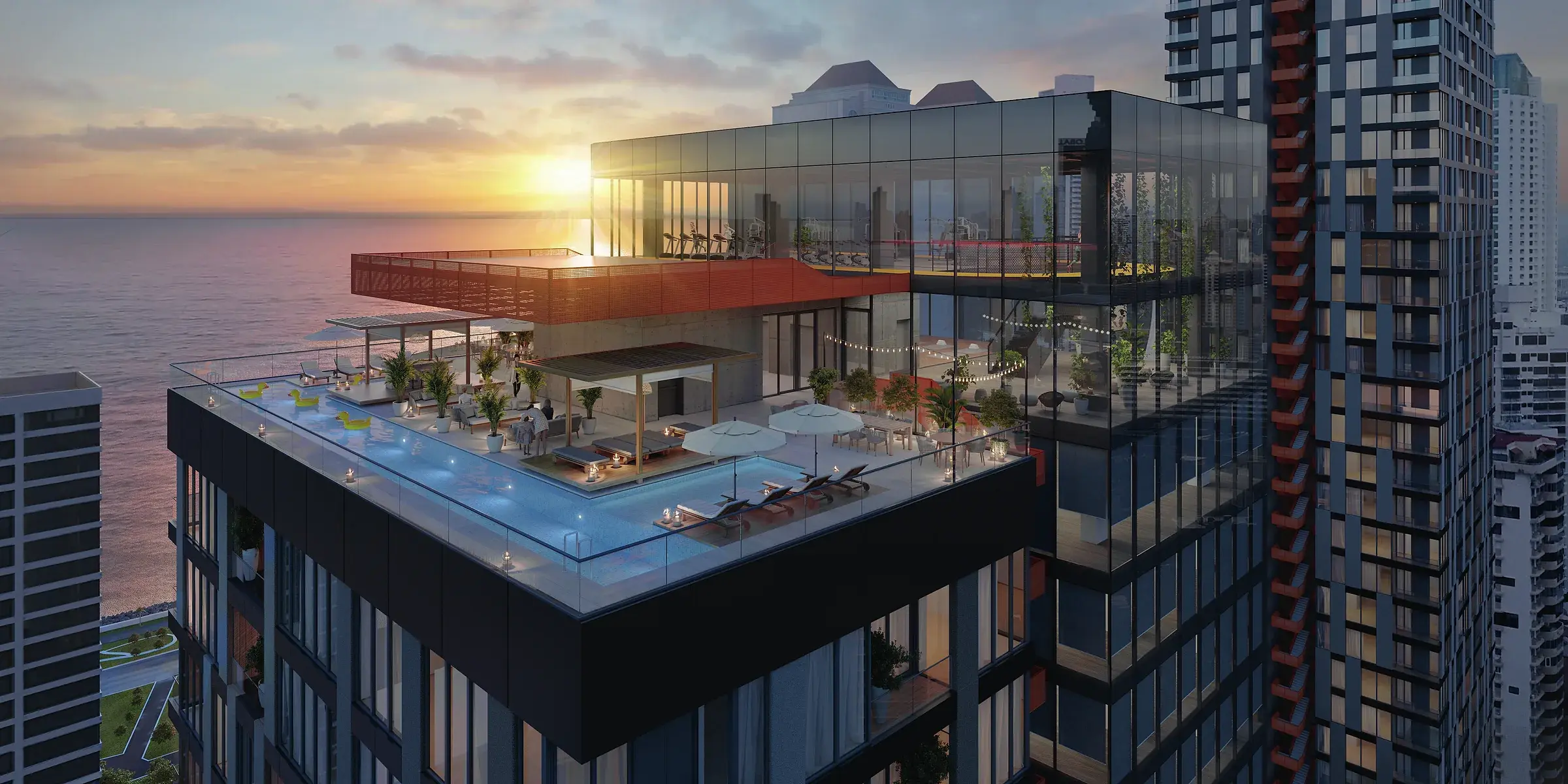 Architectural render of the Uptown Condo Suites rooftop at sunset, with an infinity pool, lounge pavilion and a glazed gym level facing the sea.